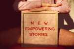 a person holding a sign that says new empowering stories