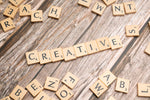 scrabble tiles spelling out the word creative