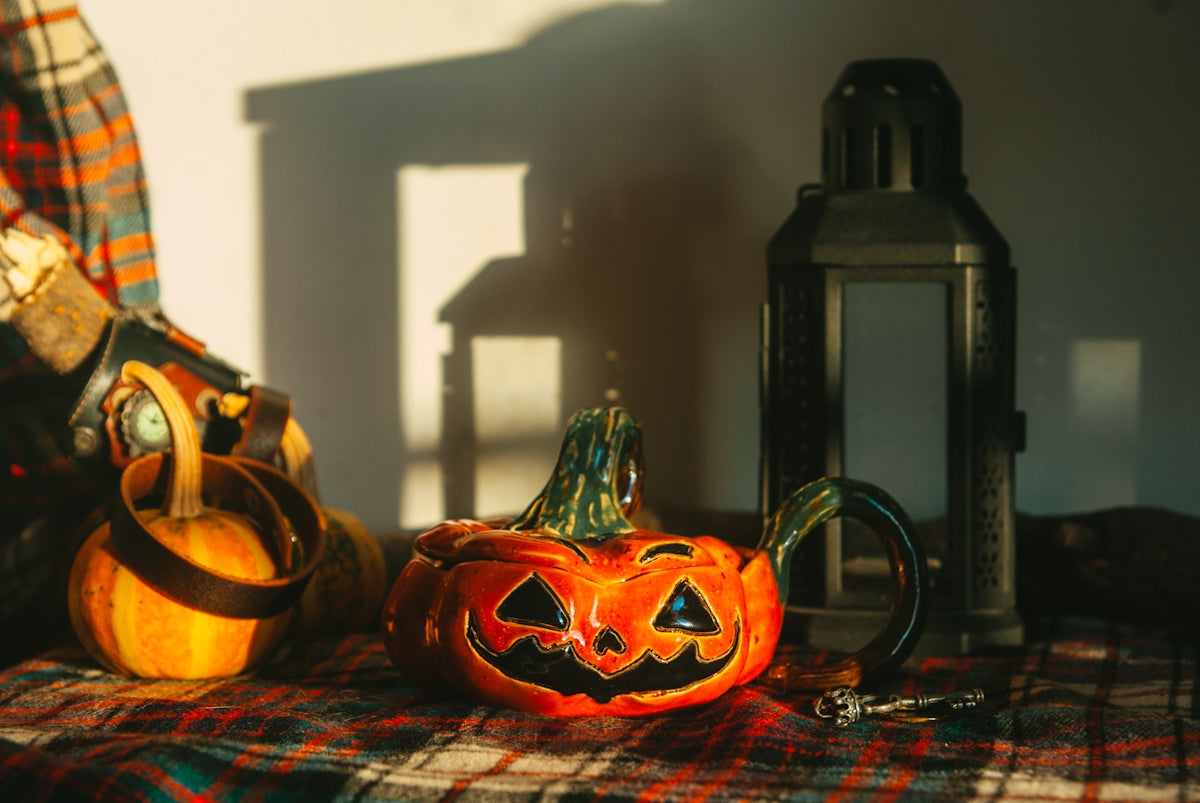 a pumpkin sitting on top of a table next to a lantern