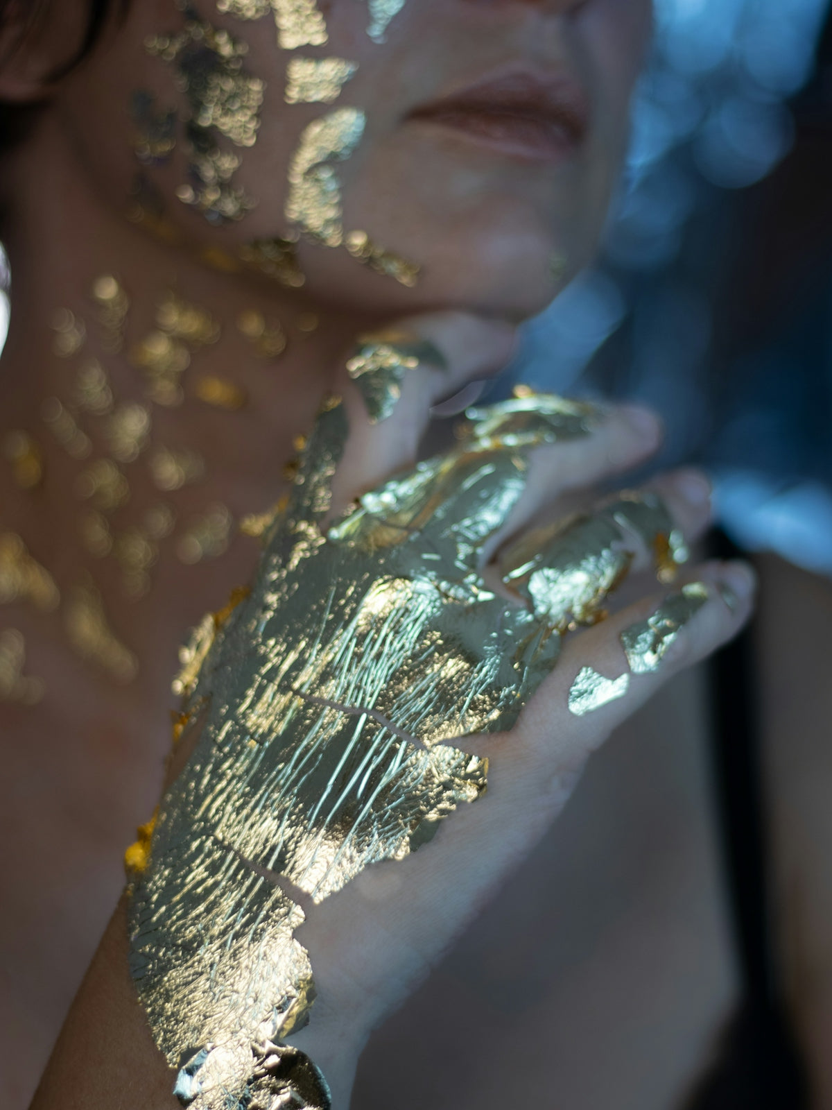 A woman with gold paint on her hands