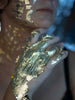 A woman with gold paint on her hands