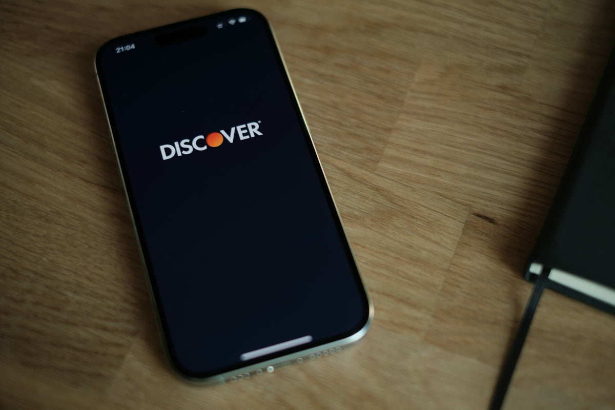 A cell phone sitting on top of a wooden table