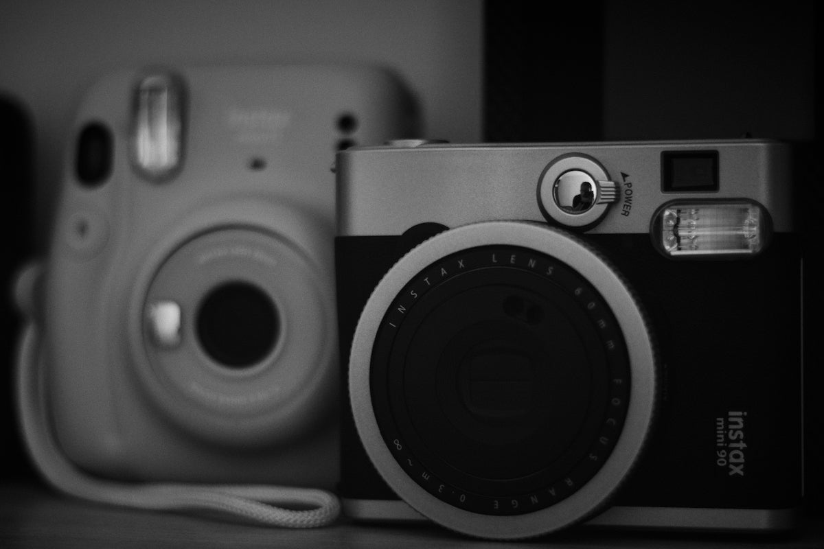 Two instax cameras are side by side.